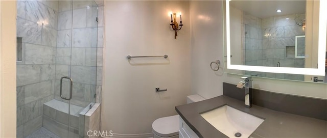 full bathroom with a shower stall, toilet, and vanity