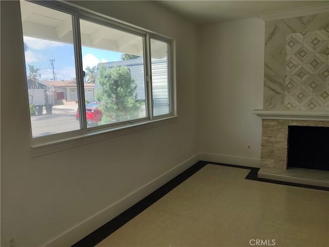 746 Hudson Ave, Costa Mesa, CA 92626 - unfurnished living room featuring baseboards and a stone fireplace