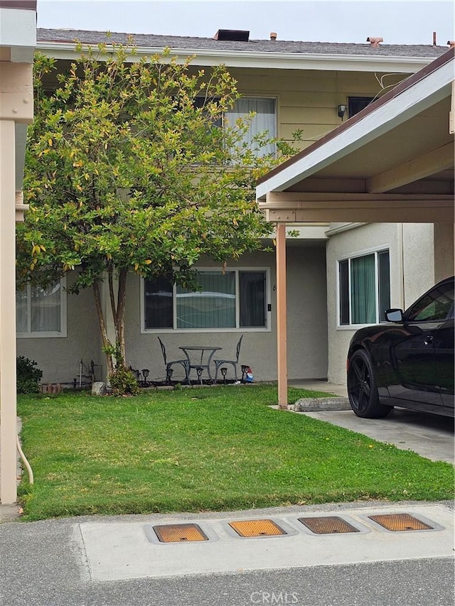 exterior space featuring a front yard and stucco siding