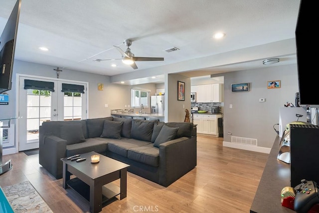 1192 Mitchell Ave Unit 66, Tustin, CA 92780 - living room with french doors, light wood-type flooring, ceiling fan, baseboards, and recessed lighting