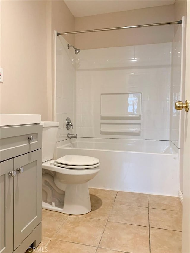 bathroom with tile patterned floors, vanity, washtub / shower combination, and toilet