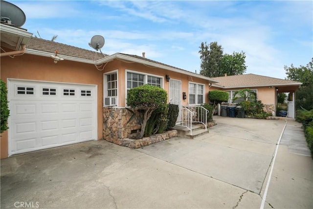 single story home featuring a garage, driveway, and stucco siding