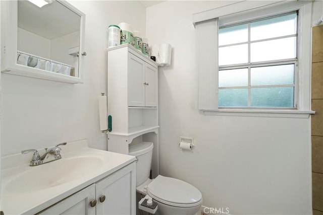 full bathroom with toilet and vanity
