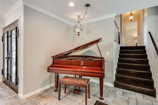 sitting room with crown molding, stone tile flooring, baseboards, and stairway