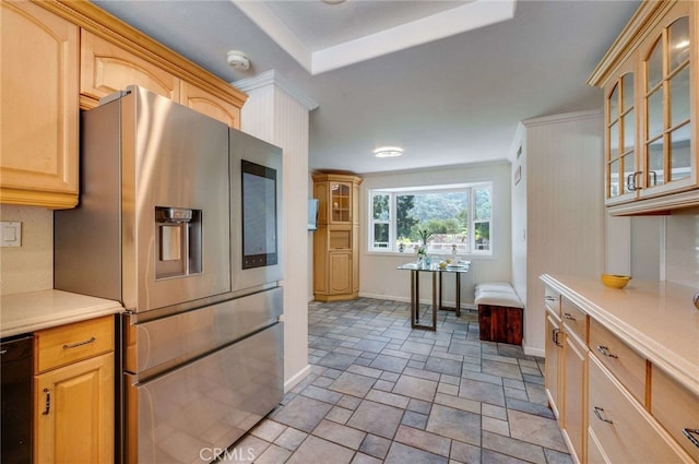 kitchen with glass insert cabinets, stone finish floor, light countertops, stainless steel fridge, and baseboards