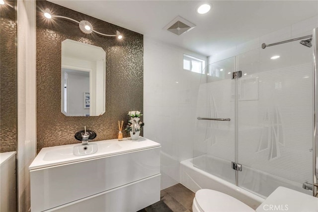 full bath with combined bath / shower with glass door, vanity, recessed lighting, toilet, and visible vents