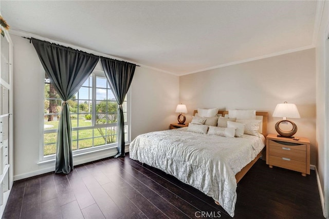 bedroom with ornamental molding, baseboards, and dark wood-style floors