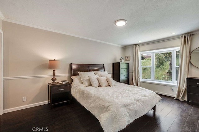 bedroom featuring dark wood-type flooring, crown molding, and baseboards