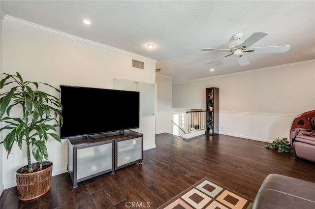 living area featuring visible vents, wainscoting, and wood finished floors