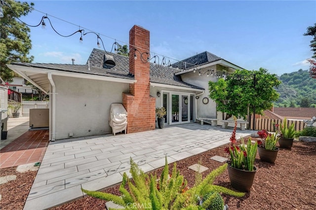 back of property featuring a patio area, french doors, fence, and stucco siding