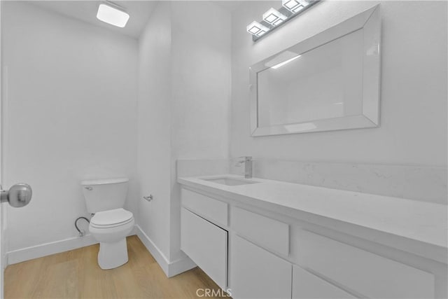 28121 Highridge Rd Unit 402, Rancho Palos Verdes, CA 90275 - bathroom featuring toilet, vanity, wood finished floors, and baseboards