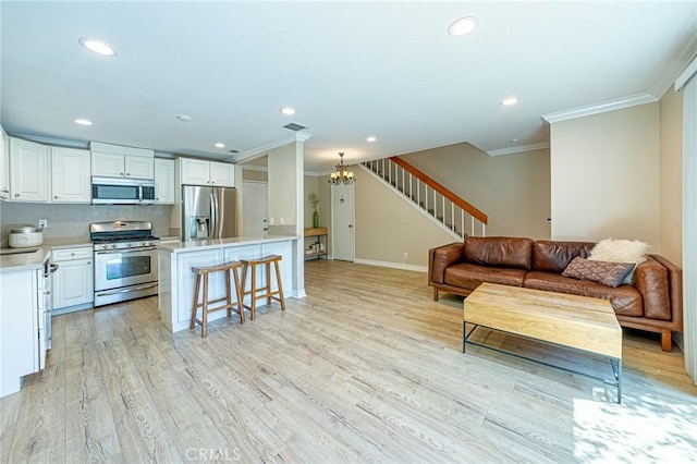 2735 Piedmont Ave Unit 3, Montrose, CA 91020 - living area featuring light wood-type flooring, a chandelier, crown molding, stairway, and recessed lighting