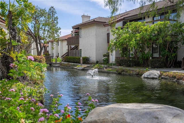 view of water feature with a small pond