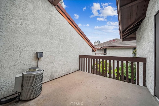 view of patio with a balcony and central AC