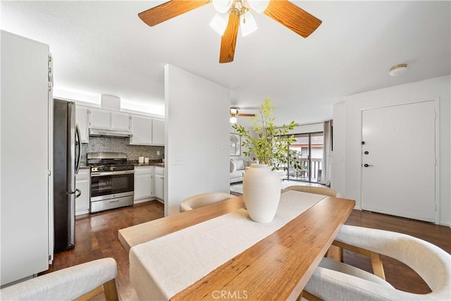 dining area with dark wood-style flooring and ceiling fan