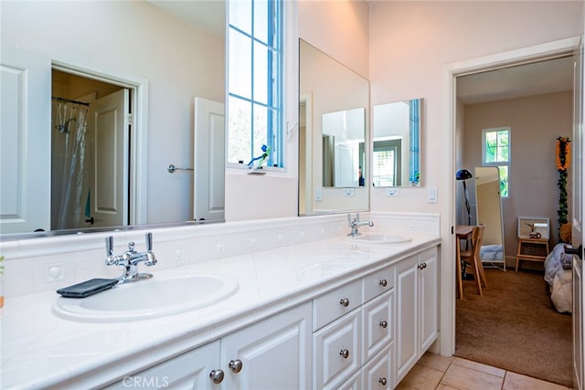 1550 Hibiscus Ave, Azusa, CA 91702 - ensuite bathroom featuring tile patterned floors, double vanity, ensuite bath, and a sink