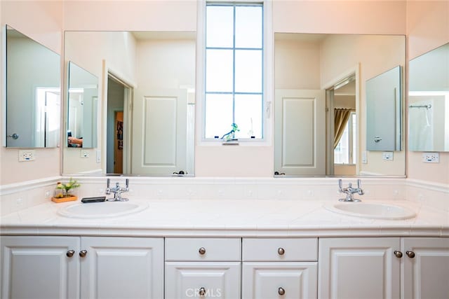 1550 Hibiscus Ave, Azusa, CA 91702 - full bathroom with a wealth of natural light, double vanity, and a sink