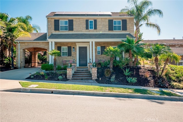 1550 Hibiscus Ave, Azusa, CA 91702 - view of front of home featuring concrete driveway, stone siding, and solar panels