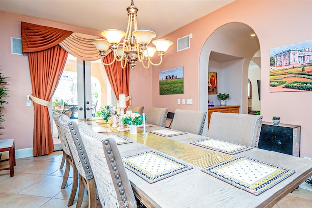 1550 Hibiscus Ave, Azusa, CA 91702 - tiled dining room with arched walkways, visible vents, french doors, baseboards, and a notable chandelier