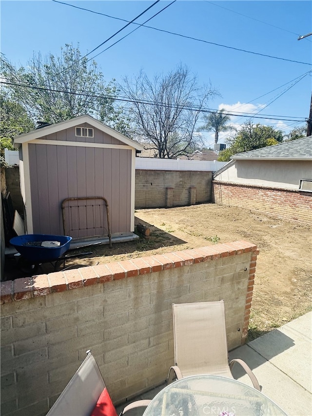16624 Kelsloan St, Lake Balboa, CA 91406 - view of patio featuring a storage unit, an outdoor structure, and a fenced backyard