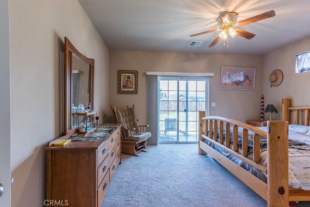 bedroom with light carpet, access to exterior, multiple windows, and visible vents