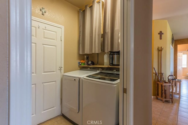 washroom with laundry area, light tile patterned floors, and washing machine and clothes dryer