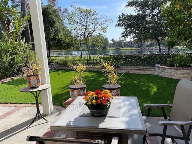 sunroom featuring a water view