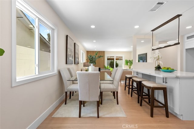 dining space with light wood finished floors, visible vents, and recessed lighting