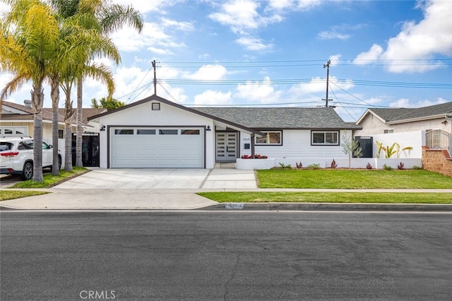 ranch-style home with a garage, a front yard, and concrete driveway