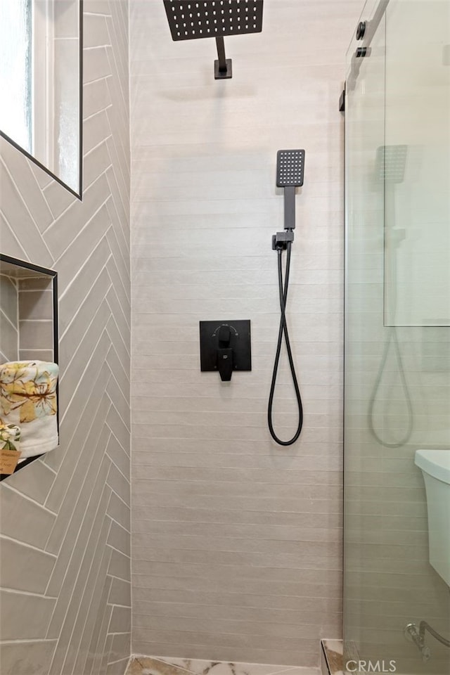 full bathroom with tiled shower