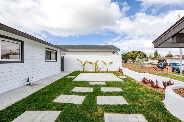 view of yard with a patio and fence