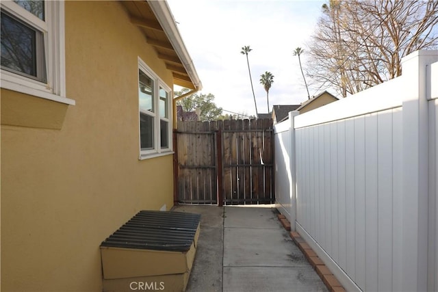 view of home's exterior with fence and stucco siding