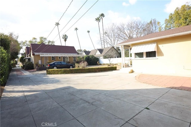 exterior space featuring driveway and fence