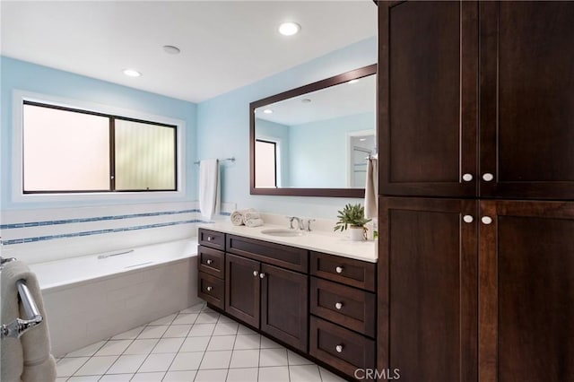 bathroom featuring tile patterned flooring, a garden tub, vanity, and recessed lighting