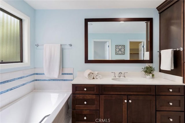 bathroom with a bath and vanity