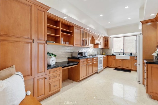kitchen featuring recessed lighting, dark countertops, a sink, white appliances, and decorative backsplash