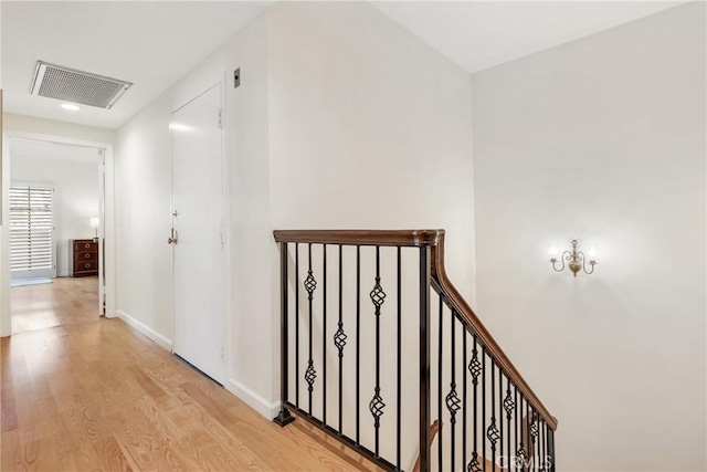 hall with recessed lighting, light wood-type flooring, visible vents, and baseboards