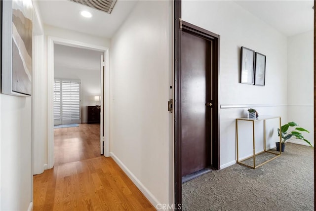 hall featuring recessed lighting, baseboards, visible vents, and light wood-style flooring