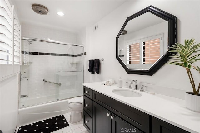 bathroom with shower / bath combination with glass door, tile patterned flooring, visible vents, toilet, and vanity