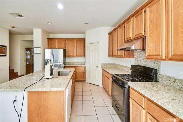 kitchen with stainless steel fridge with ice dispenser, gas stove, extractor fan, visible vents, and a sink