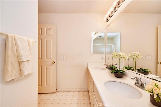 full bathroom with tile patterned floors, double vanity, and a sink