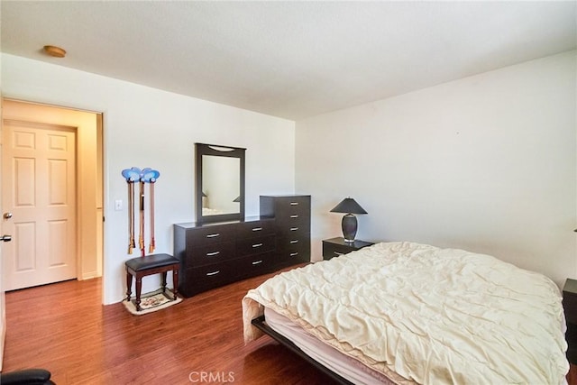 bedroom featuring dark wood finished floors