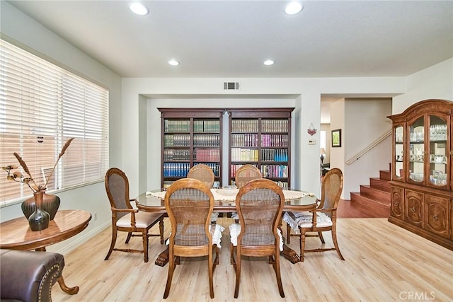 dining room with visible vents, light wood-type flooring, stairway, and recessed lighting
