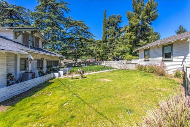 view of yard featuring cooling unit and fence