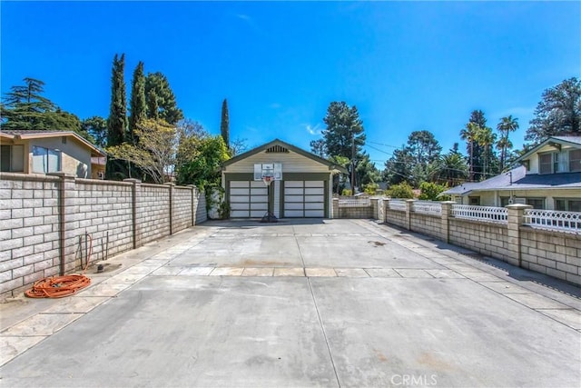 detached garage featuring fence