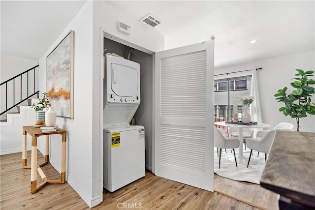 131 S Atlantic Blvd Unit A, Alhambra, CA 91801 - washroom with stacked washing machine and dryer, light wood-style flooring, recessed lighting, and baseboards