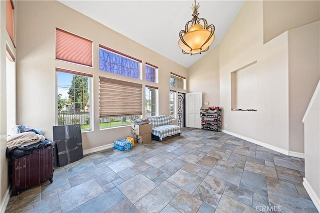 1010 W Wilson St, Pomona, CA 91768 - sitting room with stone tile flooring, baseboards, and high vaulted ceiling