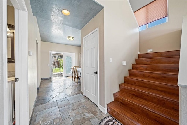 1010 W Wilson St, Pomona, CA 91768 - stairs with baseboards and stone tile floors