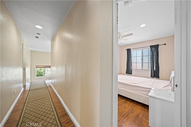 1010 W Wilson St, Pomona, CA 91768 - hall with wood finished floors, baseboards, and a textured wall