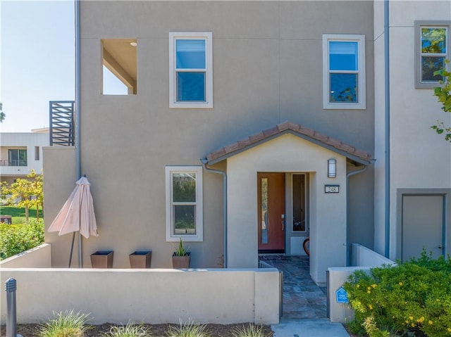248 Keeper, Irvine, CA 92618 - view of front of house with stucco siding and a fenced front yard